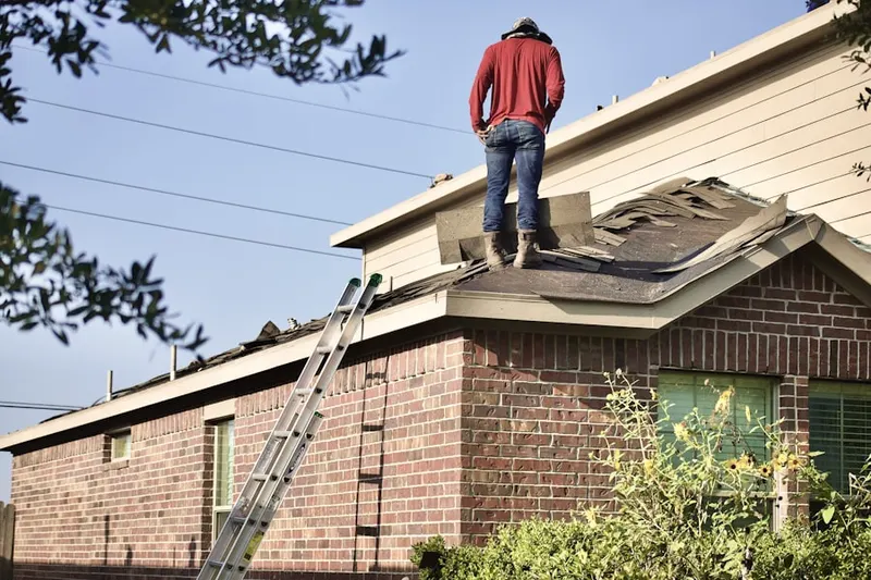 Professional roofer working on a residential roof in Crystola